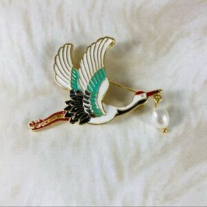 Beautiful little Japanese crane pin with a dangling Pearl in his beak.